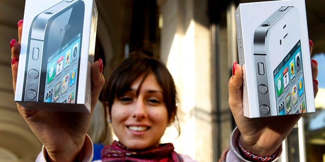 Oct. 14, 2011: Fehmeeda Bakhshi from Reading, England, holds up her purchase of two iPhone 4S smartphones outside the Apple Store in Covent Garden.