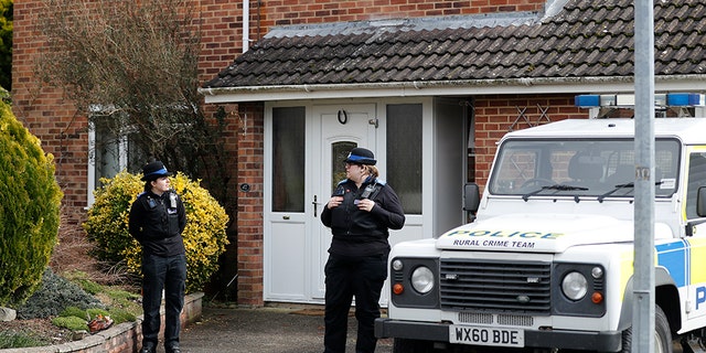 In this Tuesday, March 6, 2018 file photo, police officers stand outside the house of former Russian double agent Sergei Skripal in Salisbury, England. British police say they believe a Russian ex-spy and his daughter first came into contact with a military-grade nerve agent at their front door.
