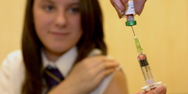 Lucy Butler,15, gets ready to have her measles shot at All Saints School in Ingleby Barwick, Teesside, England, as a national vaccination catch-up campaign has been launched to curb a rise in measles cases in England.