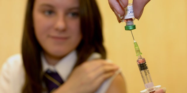 Lucy Butler,15, gets ready to have her measles shot at All Saints School in Ingleby Barwick, Teesside, England, as a national vaccination catch-up campaign has been launched to curb a rise in measles cases in England.