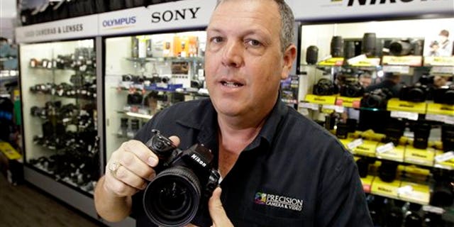 In this April 21, 2011 photo, Gregg Burger, general manager of Precision Camera, an independent retailer, poses for a photo at his store, in Austin, Texas. Burger has lobbied for legislation that would require out-of-state Internet retailers to collect Texas sales tax, creating what he calls a level playing field for local retailers.