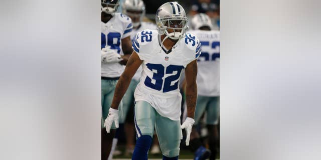 In this Aug. 28, 2014 photo, Dallas Cowboys cornerback Orlando Scandrick warms up before a NFL preseason football game against the Denver Broncos in Arlington, Texas. Scandrick will be back on the practice field two weeks early after his four-game suspension was reduced with the new agreement between the players and the league on a performance-enhancing drugs policy.(AP Photo/Brandon Wade)