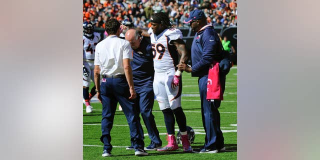 Denver Broncos outside linebacker Danny Trevathan (59) is helped off the field in the first quarter of an NFL football game against New York Jets, Sunday, Oct. 12, 2014, in East Rutherford, N.J. The Denver Broncos await test results on Trevathan's left leg, the same one he fractured in training camp. (AP Photo/Bill Kostroun)