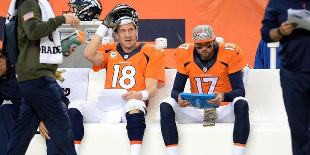 Nov 15, 2015; Denver, CO, USA; Denver Broncos quarterback Peyton Manning (18) sits on the bench along with quarterback Brock Osweiler (17) in the fourth quarter against the Kansas City Chiefs at Sports Authority Field at Mile High. Mandatory Credit: Ron Chenoy-USA TODAY Sports