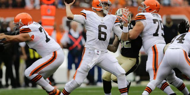 FILE - In this Sept. 14, 2014, file photo, Cleveland Browns quarterback Brian Hoyer (6) passes against the New Orleans Saints in an NFL football game in Cleveland. With two Pro Bowlers, an impressive rookie, a journeyman guard and right tackle who became a scapegoat last season, Cleveland's offensive line has been the team's strength so far this season. The unit has protected Hoyer and paved the way for one of the league's best running games.(AP Photo/Tony Dejak, File)