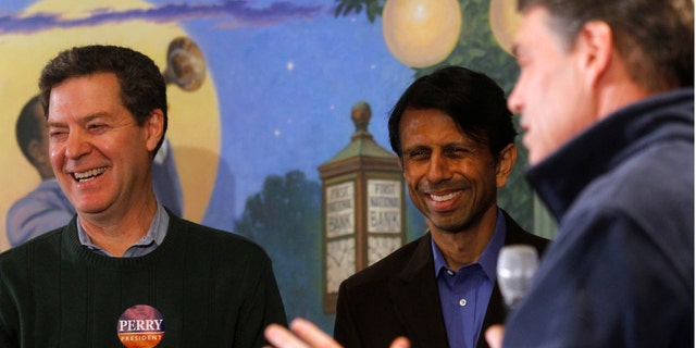 FILE: January 2, 2012: Kansas Gov. Sam Brownback (L), Louisiana Governor Bobby Jindal (C) and then-GOP presidential candidate and Texas Gov. Rick Perry in Perry, Iowa.