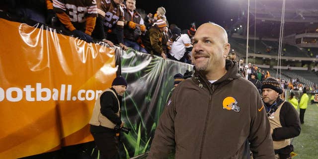 Cleveland Browns coach Mike Pettine smiles as he leave the field following the Browns' 24-3 in an NFL football game against the Cincinnati Bengals on Thursday, Nov. 6, 2014, in Cincinnati. (AP Photo/Michael Conroy)