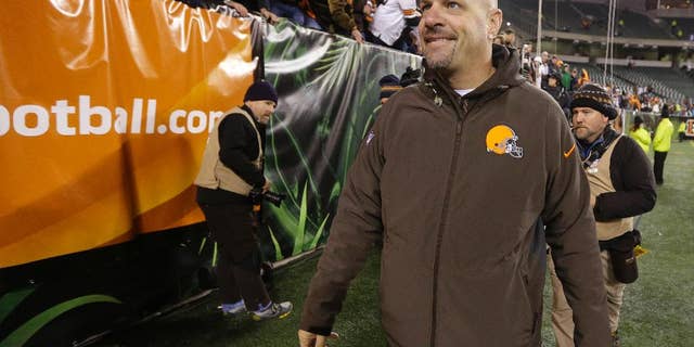 Cleveland Browns coach Mike Pettine smiles as he leave the field following the Browns' 24-3 in an NFL football game against the Cincinnati Bengals on Thursday, Nov. 6, 2014, in Cincinnati. (AP Photo/Michael Conroy)