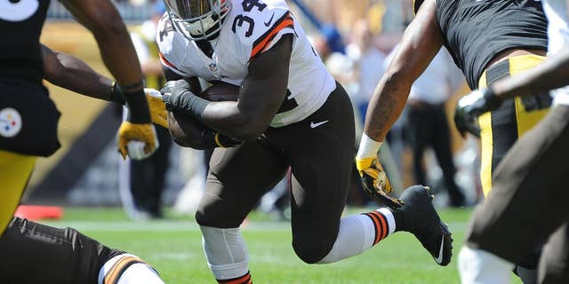 FILE -This Sunday, Sept. 7, 2014, file photo shows Cleveland Browns running back Isaiah Crowell (34) carrying the ball against the Pittsburgh Steelers during the third quarter of an NFL football game in Pittsburgh. With starting running back Ben Tate expected to miss Sunday's, Sept. 14, 2014, game with a knee injury, the Browns will again turn to rookies Terrance West and Crowell this week against New Orleans. West rushed for 100 yards, 91 in the second half, and Crowell had two touchdowns in their debuts last week against Pittsburgh. (AP Photo/Don Wright, File)