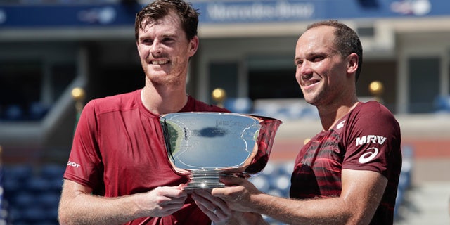 Jamie Murray, of the United Kingdom, left, and Bruno Soares, of Brazil, pose for a photo with the championship trophy after beating Pablo Carreno Busta, of Spain, and Guillermo Garcia-Lopez, of Spain, to win the men's doubles final of the U.S. Open tennis tournament, Saturday, Sept. 10, 2016, in New York. (AP Photo/Julie Jacobson)