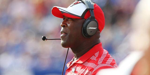 Tampa Bay Buccaneers head coach Lovie Smith watches his team play during the first half of a preseason NFL football game against the Buffalo Bills Saturday, Aug. 23, 2014, in Orchard Park, N.Y. The Buccaneers won the game 27-14. (AP Photo/Bill Wippert)