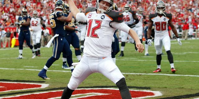 FILE - In this Sept. 14, 2014, file photo, Tampa Bay Buccaneers quarterback Josh McCown spikes the football after scoring on a 5-yard touchdown run against the St. Louis Rams during an NFL football game in Tampa, Fla. Hoping to spark one of the NFL's least productive offenses, the Buccaneers are turning back to McCown at quarterback.The 12th-year pro started the first three games of the season, but has missed the past five after injuring the thumb on his throwing hand. (AP Photo/Brian Blanco, File)