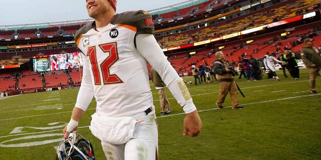 Tampa Bay Buccaneers quarterback Josh McCown (12) smiles as he walks off the field after a 27-7 victory over the Washington Redskins in an NFL football game in Landover, Md., Sunday, Nov. 16, 2014. (AP Photo/Alex Brandon)
