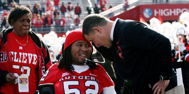 Nov. 19, 2011: In this record photo, inept former Rutgers football actor Eric LeGrand, center, is greeted by manager Greg Schiano, right, before an NCAA college football diversion opposite Cincinnati in Piscataway, N.J.