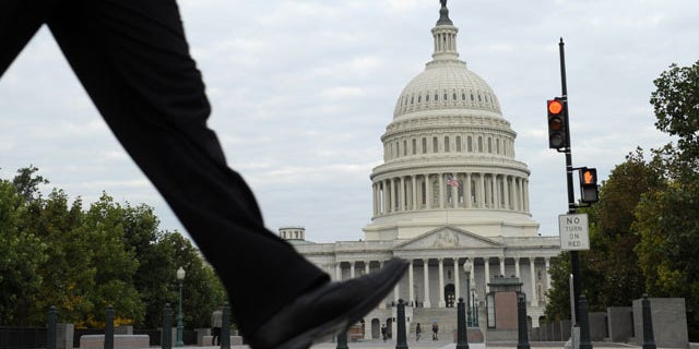 October 1, 2013: People walk near Capitol Hill in Washington. (AP Photo)