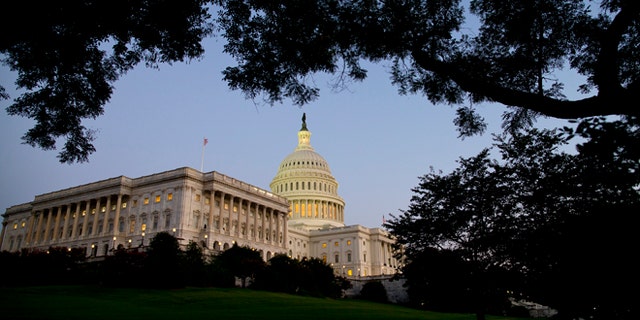 Dusk falls over the Capitol building as the budget battle continues on Monday, Sept. 30, 2013 in Washington. President Barack Obama ramped up pressure on Republicans Monday to avoid a post-midnight government shutdown, saying that failure to pass a short-term spending measure to keep agencies operating would "throw a wrench into the gears" of a recovering economy. (AP Photo/ Evan Vucci)