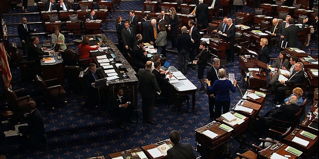 In this video image from Senate Television, senators speak on the floor of the U.S. Senate during voting on an amendment to the budget resolution at the Capitol on Washington, Friday, March 22, 2013. (AP Photo/Senate Television)