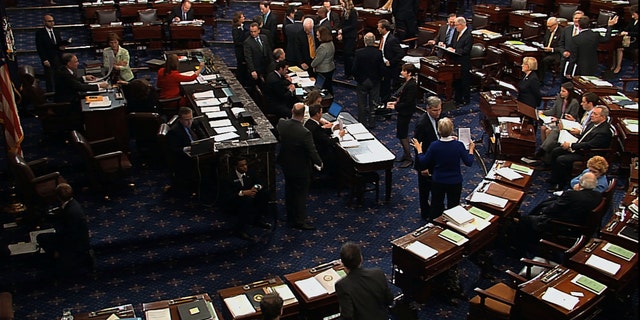 In this video image from Senate Television, senators speak on the floor of the U.S. Senate during voting on an amendment to the budget resolution at the Capitol on Washington, Friday, March 22, 2013. (AP Photo/Senate Television)