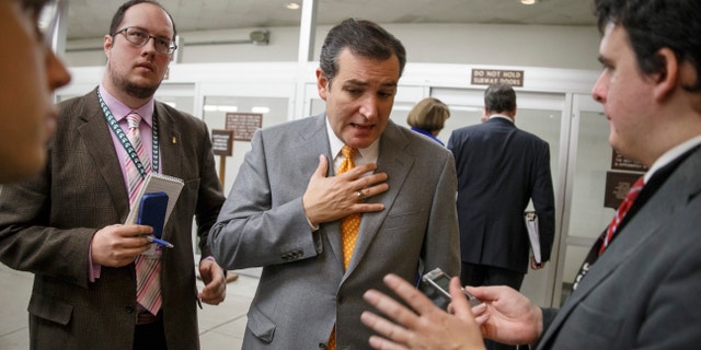Sen. Ted Cruz, R-Texas speaks with reporters on Capitol Hill in Washington, Tuesday, Dec. 17, 2013, after a bipartisan budget compromise cleared a procedural hurdle in the Senate, advancing past a filibuster threshold on a 67-33 vote that ensures the measure will pass the Democratic-led chamber no later than Wednesday and head to the White House to be signed into law. When enacted, the measure would ease for two years some of the harshest cuts to agency budgets required under automatic spending curbs commonly known as sequestration. (AP Photo/J. Scott Applewhite)