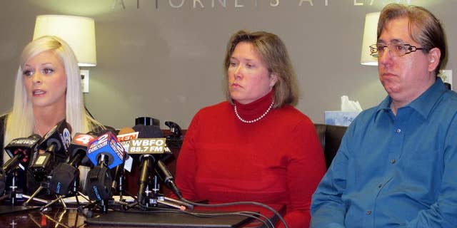 Vanessa DeRosa, left, and Antonio Flores, right, along with their attorney Diane Tiveron, center, discuss their request for Pope Francis to investigate the way the Diocese of Buffalo has handled complaints of sexual abuse, during a news conference in Tiveron's office in Amherst, N.Y., on Tuesday, Jan. 27, 2015. DeRosa and Flores say they were victimized as teenagers by employees of the diocese, which had no immediate comment. (AP Photo/Carolyn Thompson)