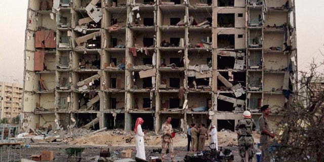 JUNE 1996: U.S. and Saudi investigators work into the night searching for clues outside the apartment building destroyed by a bomb at the Khobar Towers housing complex for U.S. military personnel in Dhahran.