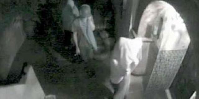 A video still from a surveillance camera provided by the Los Angeles Police Department shows three suspects attempting to enter the Hollywood Hills home of actress Lindsay Lohan in August 2009 in Los Angeles.