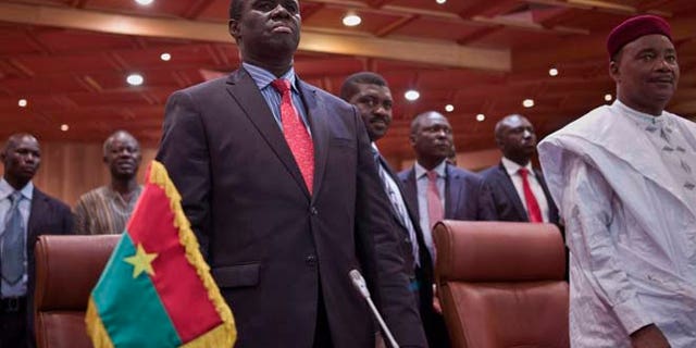 Sept. 23, 2015: Burkina Faso's transitional president Michel Kafando, left, next to Niger's President, Mahamadou Issoufou, right, during a official handover ceremony in Ouagadougou, Burkina Faso.