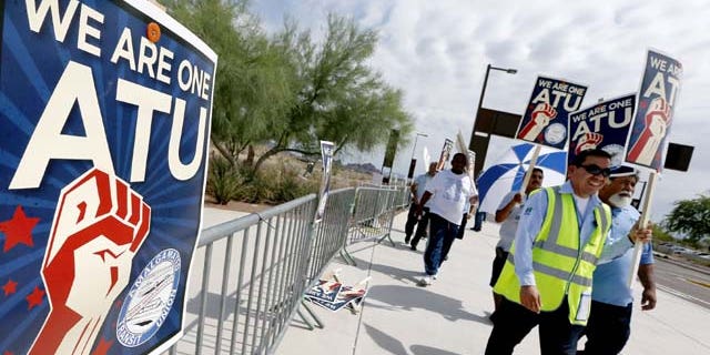 August 1, 2013: Members of the Amalgamated Transit Union Local 1433 strike in front of the First Transit Inc., bus depot in Tempe, Ariz,