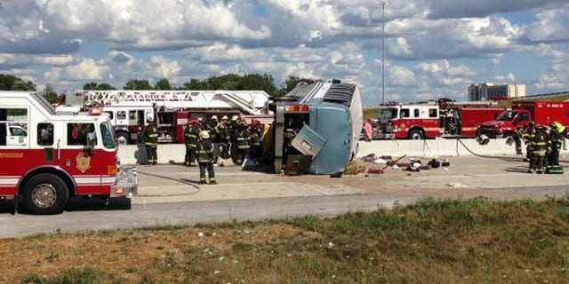 July 27, 2013: Authorities attend to an overturned bus that crashed on Interstate 465, killing three people.