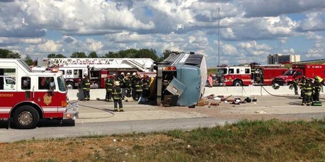 July 27, 2013: Authorities attend to an overturned bus that crashed on Interstate 465, killing three people.