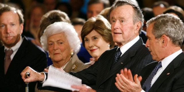 Jan. 7, 2009: Former U.S. President George H.W. Bush rises to speak at a reception in honor of the Points of Light Institute at the White House. Also pictured are Neil Bush, former first lady Barbara Bush, first lady Laura Bush, President George W. Bush.