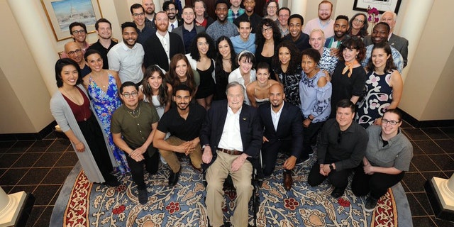 The 41st president seen posing with the cast and crew of "Hamilton."