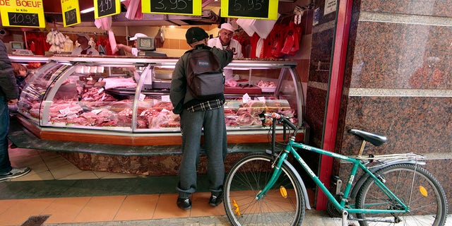 A customer is seen at the Boucherie St Francois butcher shop in the old city of Nice, France.