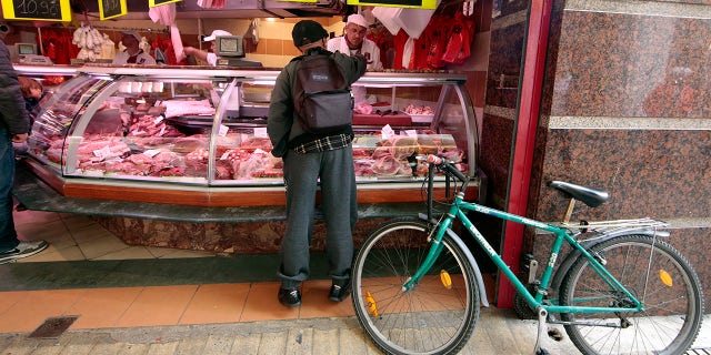 A customer is seen at the Boucherie St Francois butcher shop in the old city of Nice, France.