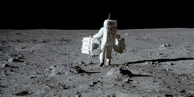 Apollo astronaut Buzz Aldrin collects moon rocks in 1969.