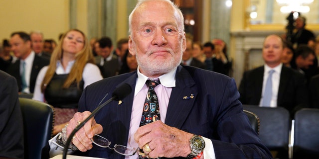 Former astronaut Buzz Aldrin takes his seat to testify before a Senate hearing on Capitol Hill in Washington, February 24, 2015.