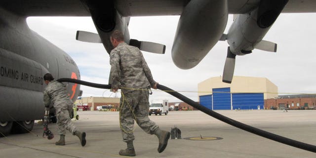 In this Wednesday April 18,2012 file photo Wyoming Air National Guard members are shown training in Cheyenne, Wyo., on using C-130 transport planes to drop fire retardant at wildfires.