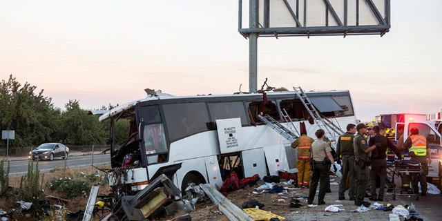 Rescue crews work at the scene of a charter bus crash in Calif., Tuesday, Aug. 2, 2016.