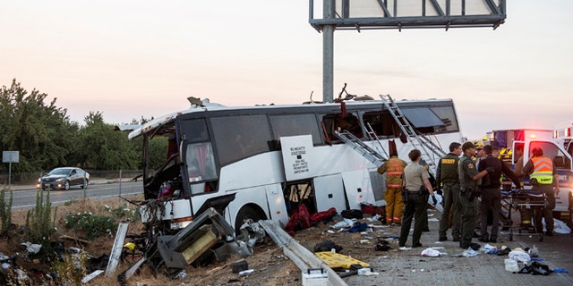 Rescue crews work at the scene of a charter bus crash in Calif., Tuesday, Aug. 2, 2016.
