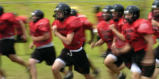 Madison High School football players run sprints during a half pad practice on Friday, Aug. 11, 2006, in Vienna, Va.  It's that time of year: Kids hit the ball fields running, and often hobble or are carried off. Back to school means back to organized sports for more than 30 million children and teenagers, and roughly 2.6 million emergency-room visits during the year for resulting injuries. Basketball, football and soccer lead the list of injury-prone team sports. (AP Photo/Kevin Wolf)