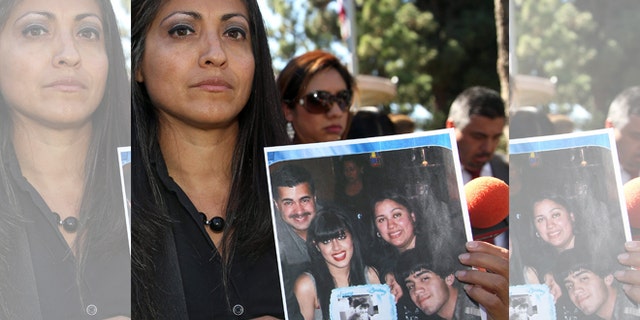 FILE - In this Oct. 2, 2014 file photo, attorney Claudia Osuna holds a photo of the Crespo family - from top left to bottom right, Bell Gardens, Calif., Mayor Daniel Crespo, his daughter Crystal, his wife Lyvette and son Daniel Crespo Jr., during a news conference in the Los Angeles surbuban city of Bell Gardens. A Los Angeles County grand jury has indicted Lyvette Crespo on a charge of voluntary manslaughter the shooting death of Daniel Crespo. The district attorneyâs office says Lyvette Crespo pleaded not guilty Thursday, April 23, 2015, during an arraignment at which the indictment was unsealed. The 45 year-old mayor was fatally shot at his home on Sept. 30, 2014. (AP Photo/Nick Ut, File)