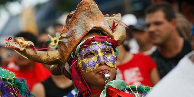 March 16, 2008: Revelers enjoy themselves as they walk along the street during the annual Calle Ocho celebration in the Little Havana neighborhood of Miami, Fla. The event is billed as the largest Hispanic festival in the nation.
