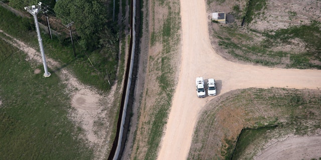 HARLINGEN, TX - MAY 21: Border Patrol officers meet near a border fence and security camera tower near the U.S.-Mexico border on May 21, 2013 near Harlingen, Texas. The area, popular with tourists as well as wildlife, is also attractive to drug smugglers bringing their product north from Mexico into the United States. (Photo by John Moore/Getty Images)