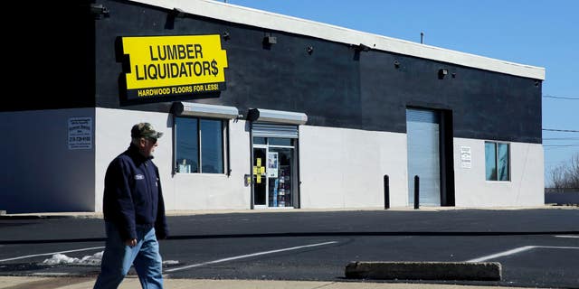 In this March 12, 2015, file photo, a man walks past a Lumber Liquidators store in Philadelphia.