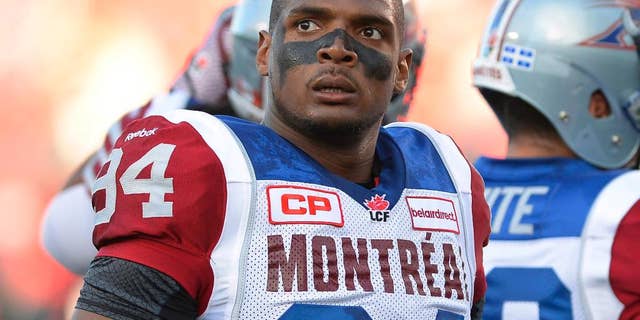 FILE - In this Aug. 7, 2014, file photo, Montreal Alouettes' Michael Sam and teammates warm up for a Canadian Football League game against the Ottawa Redblacks in Ottawa, Ontario. Sam is stepping away from pro football. Sam, the first openly gay player drafted by the NFL, has told the Alouettes that he is leaving the team. He tweeted Friday, Aug. 14, that "The last 12 months have been very difficult for me, to the point where I became concerned with my mental health. Because of this I am going to step away from the game at this time." (Justin Tang/The Canadian Press via AP, File)