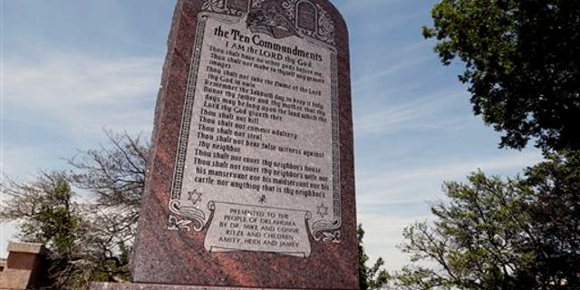 File - This June 20, 2014 file photo is the Ten Commandments monument at the state Capitol in Oklahoma City. The privately funded monument on the grounds of the Oklahoma Capitol does not violate the state constitution and can stay there, an Oklahoma County judge said Friday, Sept. 19, 2014 in a ruling that attorneys who filed the lawsuit in question vowed to appeal to the state Supreme Court. (AP Photo/Sue Ogrocki, File)
