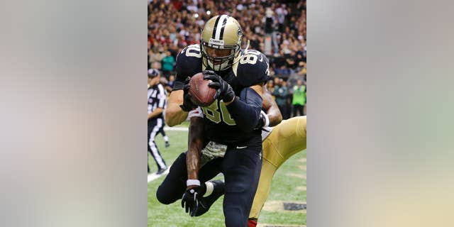 CORRECTS TO SECOND HALF - New Orleans Saints tight end Jimmy Graham (80) catches a touchdown pass in front of San Francisco 49ers cornerback Perrish Cox late in the second half of an NFL football game in New Orleans, Sunday, Nov. 9, 2014. (AP Photo/Bill Haber)