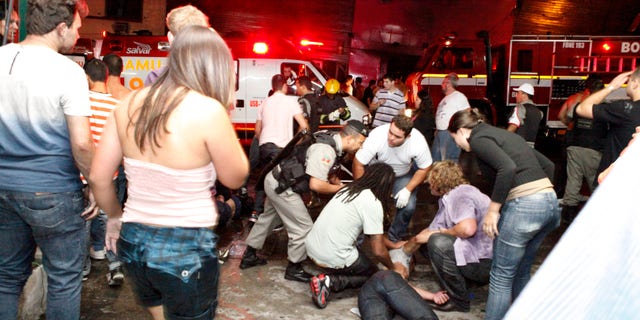 People help an injured man, victim of a nightclub fire, in Santa Maria city, Brazil, on Jan. 27, 2013.