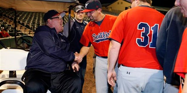 Feb. 2: Hall of Fame catcher and Palm Beach Atlantic University coach Gary Carter, left, greets players on the field before PBAU's baseball home opener at Roger Dean Stadium in Jupiter, Florida.