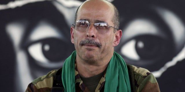 In this Jan. 13, 2002 file photo, Commander of the Revolutionary Armed Forces of Colombia, FARC, Ricardo Palmera, also known as Simon Trinidad, reads a declaration during a press conference in Los Pozos, Colombia. (AP Photo/File)